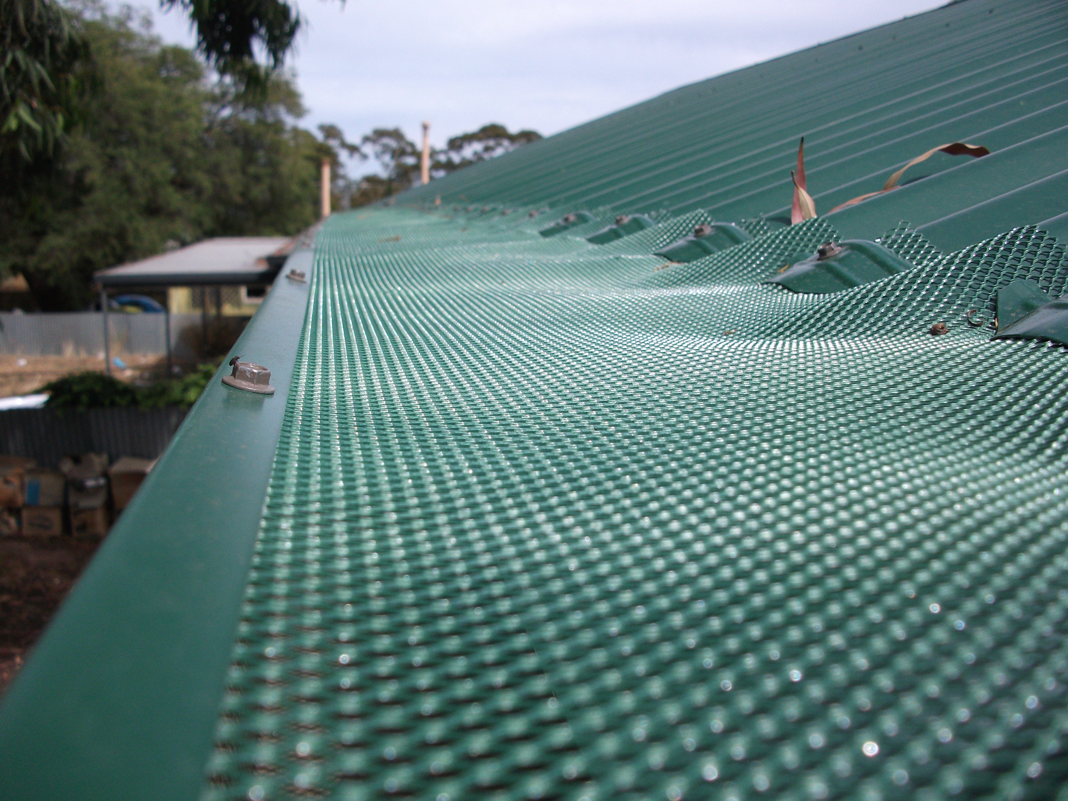 Corrugated Roof Ember and Gutter Guard installed close-up