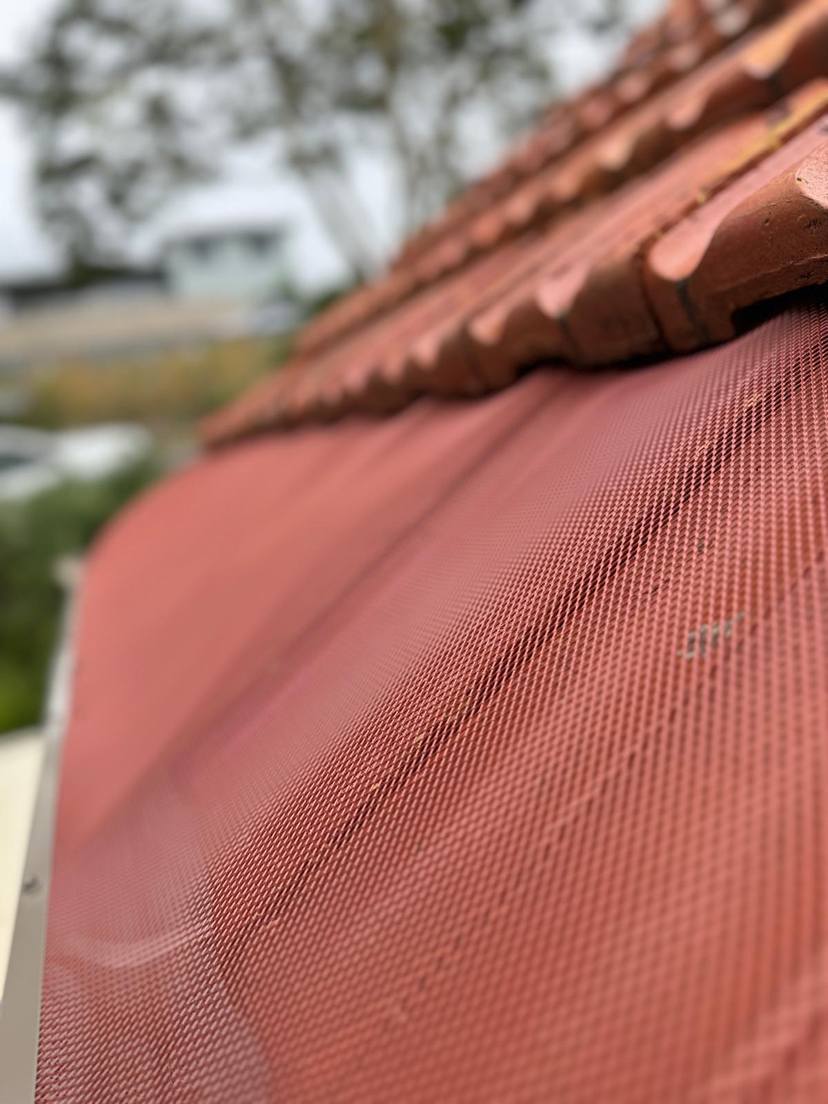 Close-up Gutter Guard installed on tiled roof